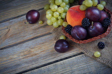Mix of fresh berries and fruits on rustic wooden background