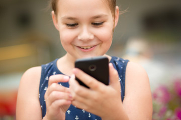 Fototapeta premium Girl is using smartphone
