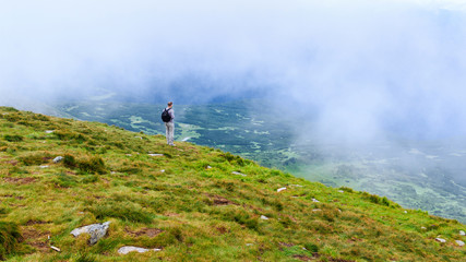Tourist looking at the landscape on the top of Hoverla mount, Carpathians.