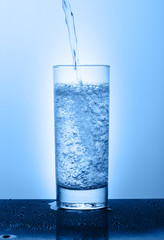 Beautiful glass with water on a blue background
