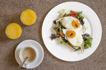 Oatmeal pancakes fresh orange juice coffee and scrambled eggs for breakfast  