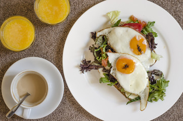 Oatmeal pancakes fresh orange juice coffee and scrambled eggs for breakfast  