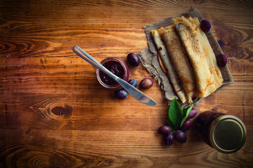 Fototapeta na wymiar Pancakes and fresh plum jam with text space