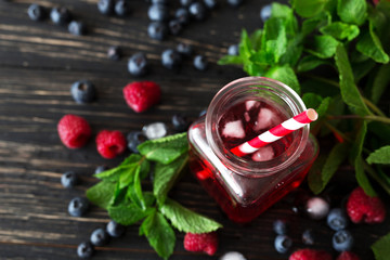 Fresh cocktail with blueberry, raspberry, mint and ice