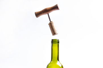 Opening a wine bottle with a corkscrew on a white background. Wine bottle with steam. Levitation of corkscrew. Isolated.
