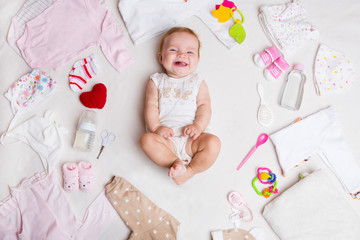 Baby on white background with clothing, toiletries, toys and health care accessories. Wish list or...