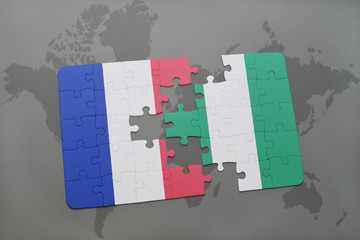puzzle with the national flag of france and nigeria on a world map background.