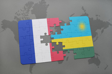 puzzle with the national flag of france and rwanda on a world map background.