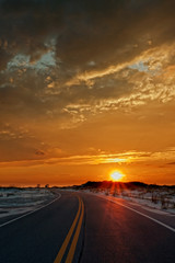 Obraz na płótnie Canvas Sunset drive through Gulf Island National Seashore toward Pensacola Beach, Florida.