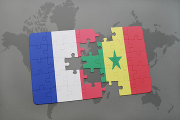 puzzle with the national flag of france and senegal on a world map background.