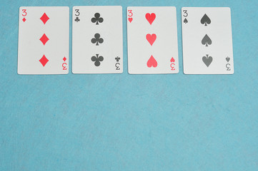 The different suits of a the number 3 card in a deck of cards di