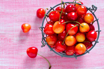 yellow and pink cherries on wooden surface