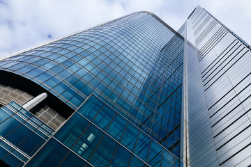 Plakat Modern glass skyscraper business center building with blue tall