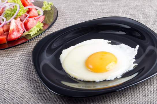 Useful homemade breakfast of fried egg and a salad