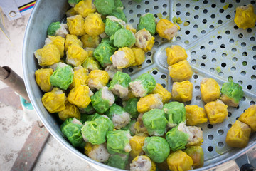 Chinese steamed pork dumpling in green and yellow color. Easy snack street food in Thailand. 
