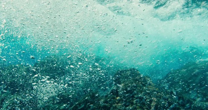 Water texture, underwater view of bubbles and waves in the ocean