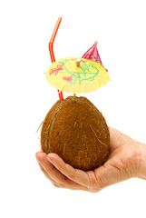 Coconut in hand with a straw and an umbrella on a white background