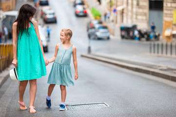 Happy mother and little adorable girl in Rome during summer italian vacation. Family european vacation.