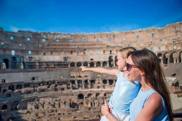 Fototapeta na wymiar Family exploring Coliseum inside in Rome, Italy. Mother and her daughter portrait at famous places in Europe