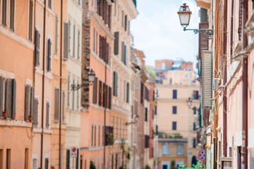 Old beautiful empty streets in Rome, Italy. Close-up of a street light at the town house