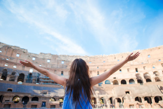 Young female tourist looking at the Colosseum inside in Rome, Italy. The Colosseum is the main tourist attractions of Rome.