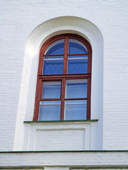 Fototapeta na wymiar Window on the white wall of the house