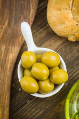 overhead shoot of green olives on rustic wooden