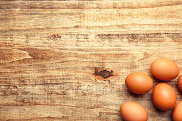 The image of eggs on a wooden table.