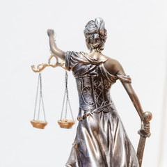 Back view of justice statue on the white background
