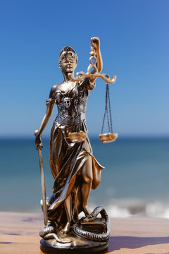 Themis - Lady of Justice on blue sky background