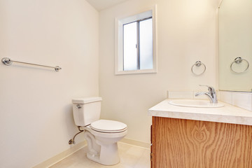 Fototapeta na wymiar White simple bathroom interior with small window.