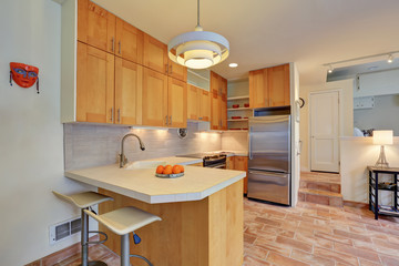 Light brown kitchen interior with steel appliances
