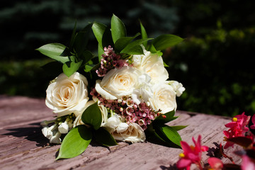 Bridal bouquet of beautiful roses for a wedding on wooden background