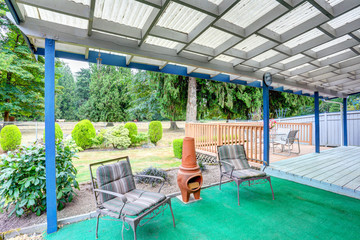 Covered back deck with outdoor seats and fire pit