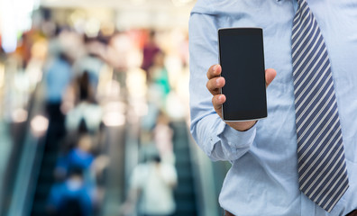 isolated business man hold the smartphone on bridge background
