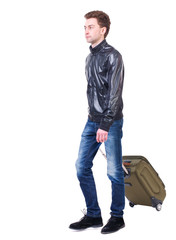 Fototapeta premium front view of walking man with suitcase. brunette guy in motion. backside view of person. Rear view people collection. Isolated over white background. young man goes to side of a rolling travel