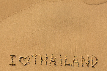 I Love Thailand - manually inscription on wet sea beach sand.
