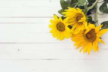 Fotobehang Achtergrond met een boeket zonnebloemen op een wit geschilderde woode © WindyNight