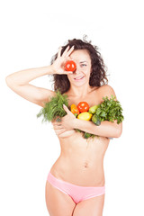 Beautiful model holding a vegetables and salad. She shows the abdomen and waist. The concept of a healthy diet and lifestyle. Weight Loss.