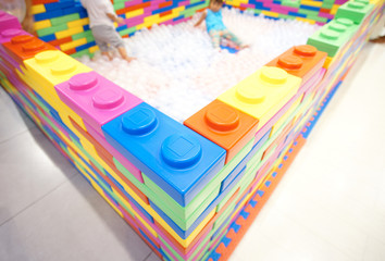 wall bricks multi colour and children being playing in playground