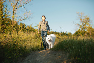 Young man playing with fun dog