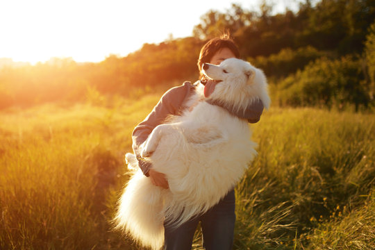 Young Man Playing With Fun Dog