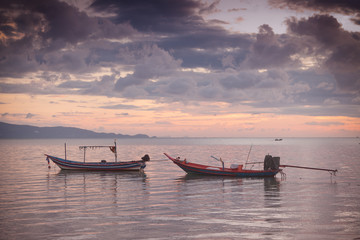 Thai traditional boats on the background of pink sunset