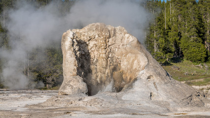 Giant Geyser roars, splashes, steams and has one of the hottest vents in the Basin. The cone is impressive; broken on one side.Upper Geyser Basin, Yellowstone National Park, Wyoming