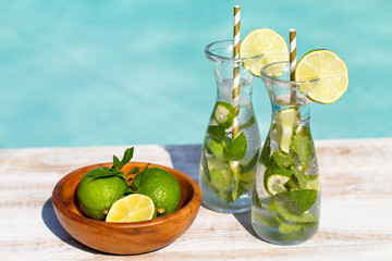 Mojito cocktail with lime and mint in highball glass on tre beach background Copy space