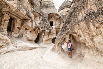 Young woman traveler in the cave city of Cappadocia, Turkey - obrazy, fototapety, plakaty