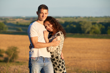 happy young couple posing high on country outdoor, romantic people concept, summer season