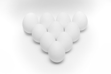 ten white eggs on white background