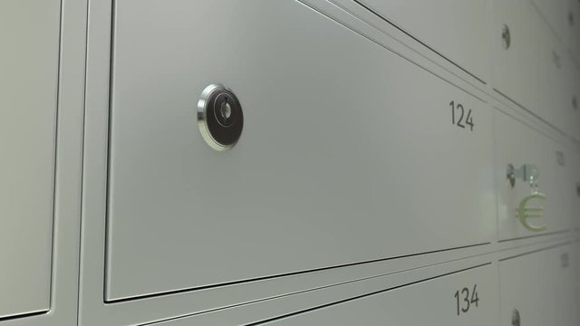 Bank safe deposit boxes and the key with euro sign keychain. Shallow focus 4K dolly clip