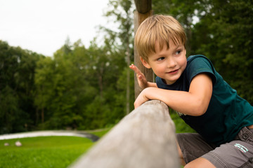 little boy in a green park close-up